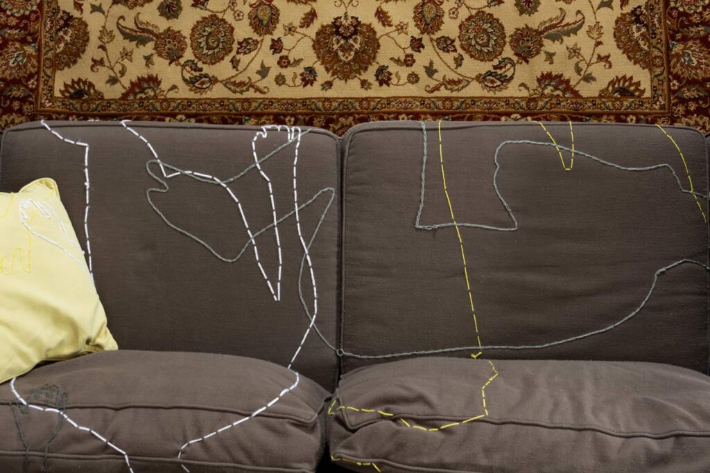 outlines of figures on a couch