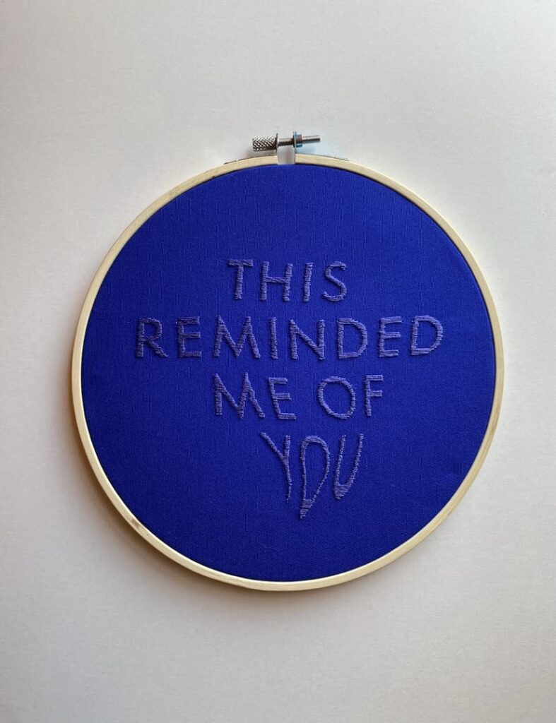 Embroidery that reads "THIS REMINDED ME OF YOU"