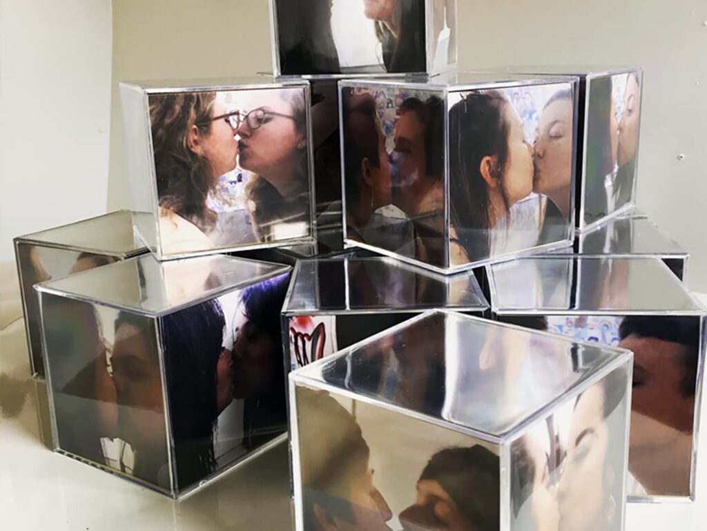 cubes with photographs of individuals kissing a mirror