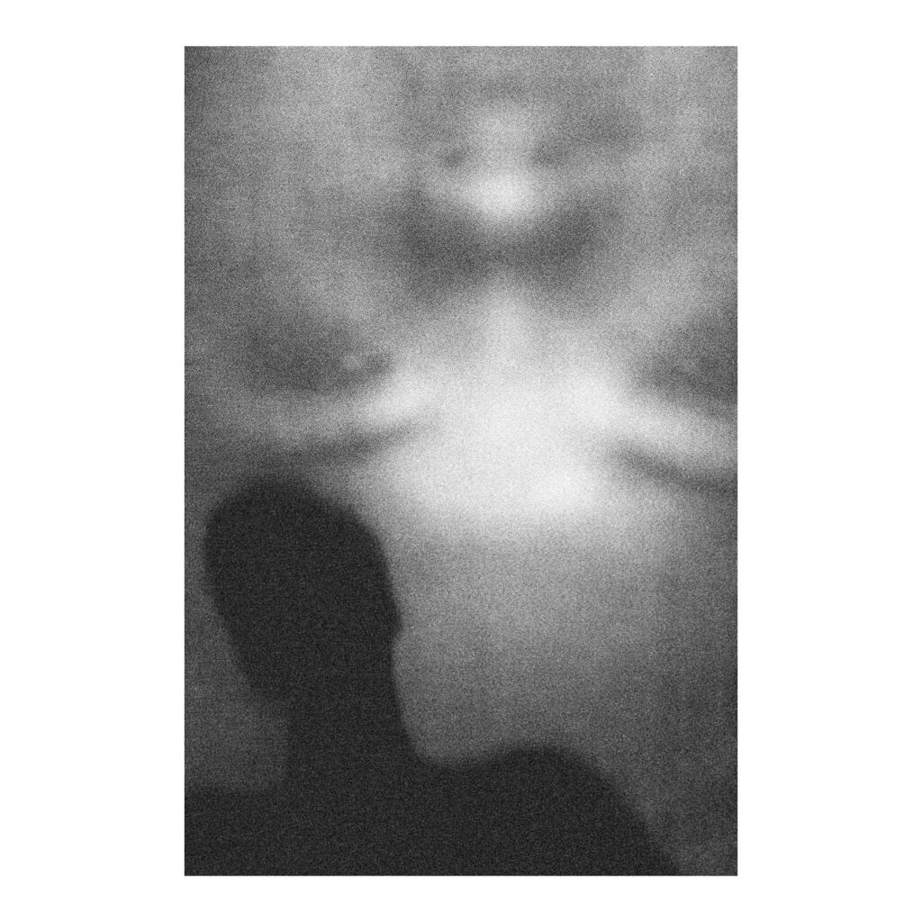 Black and White photo of a silhouette in front of a projected face